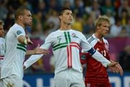 Portuguese forward Cristiano Ronaldo (C) and defender Pepe argue with the referee